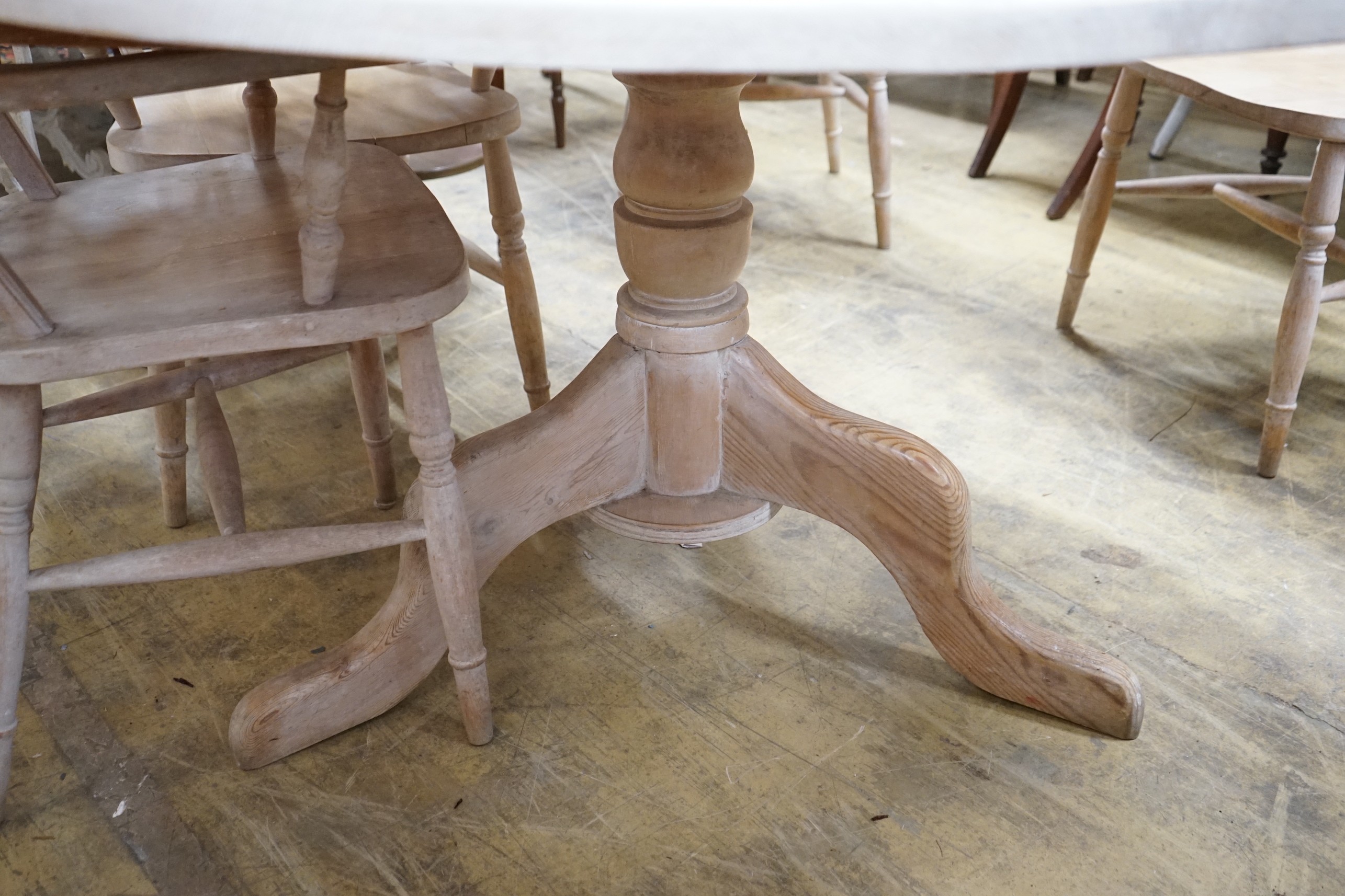 A Victorian style pine circular dining table, diameter 134cm, height 79cm